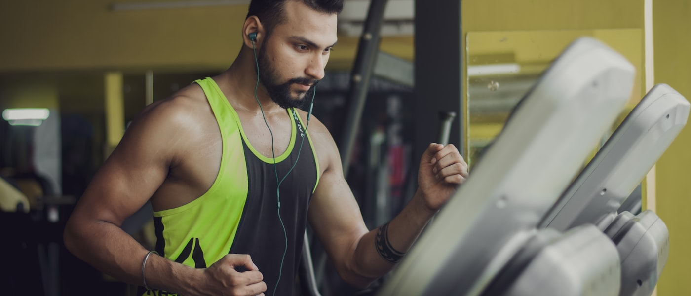 Woman strengthening muscles at a gym — health and fitness calculators